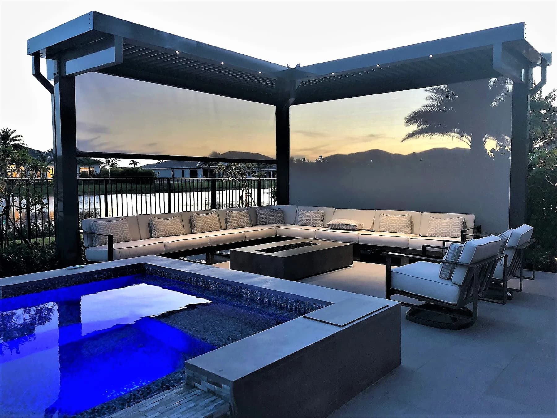 Motorized patio screen providing shade for an outdoor living area